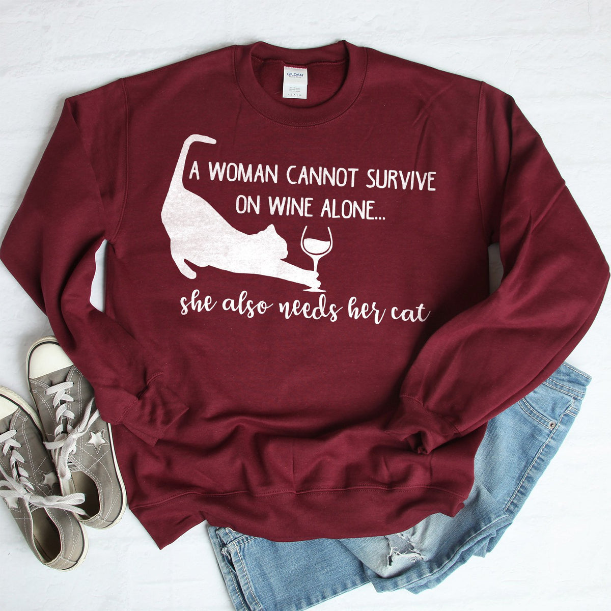 A Woman Cannot Survive on Wine Alone, She also Needs her Cat - Long Sleeve Heavy Crewneck Sweatshirt